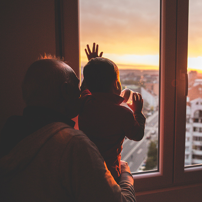 grandfather grandson looking out window