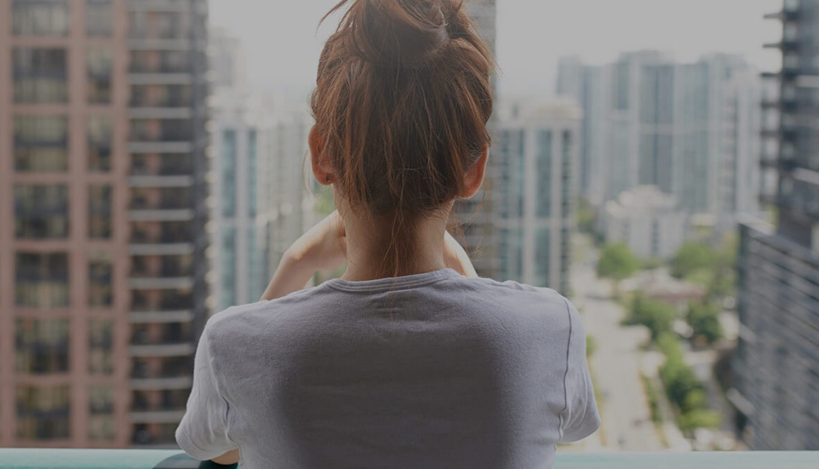 young lady looking out at to city