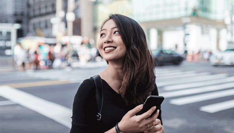 girl smiling while holding mobile